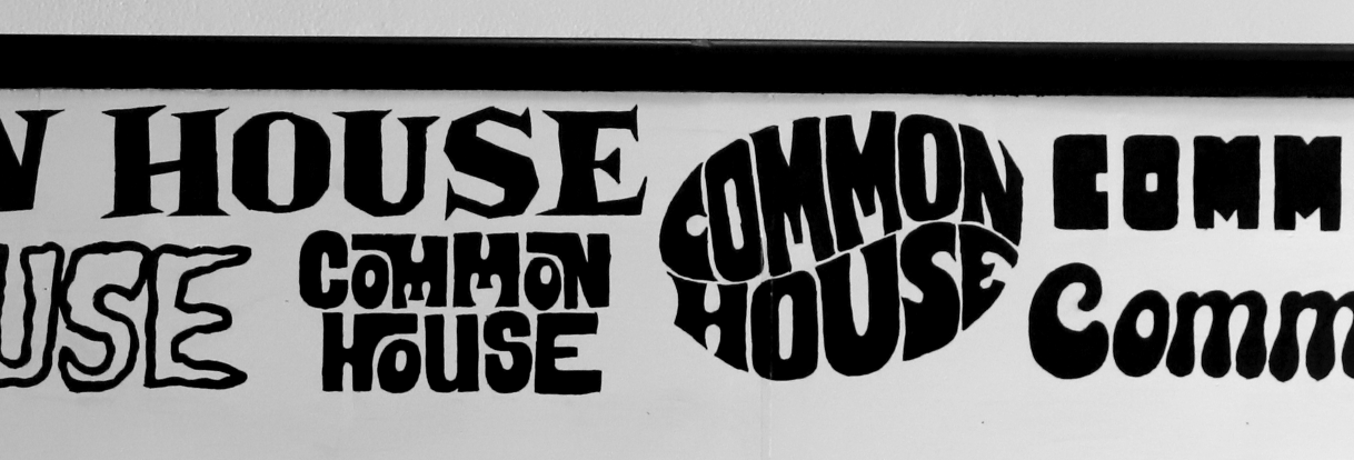 Table top with Common House logos on it