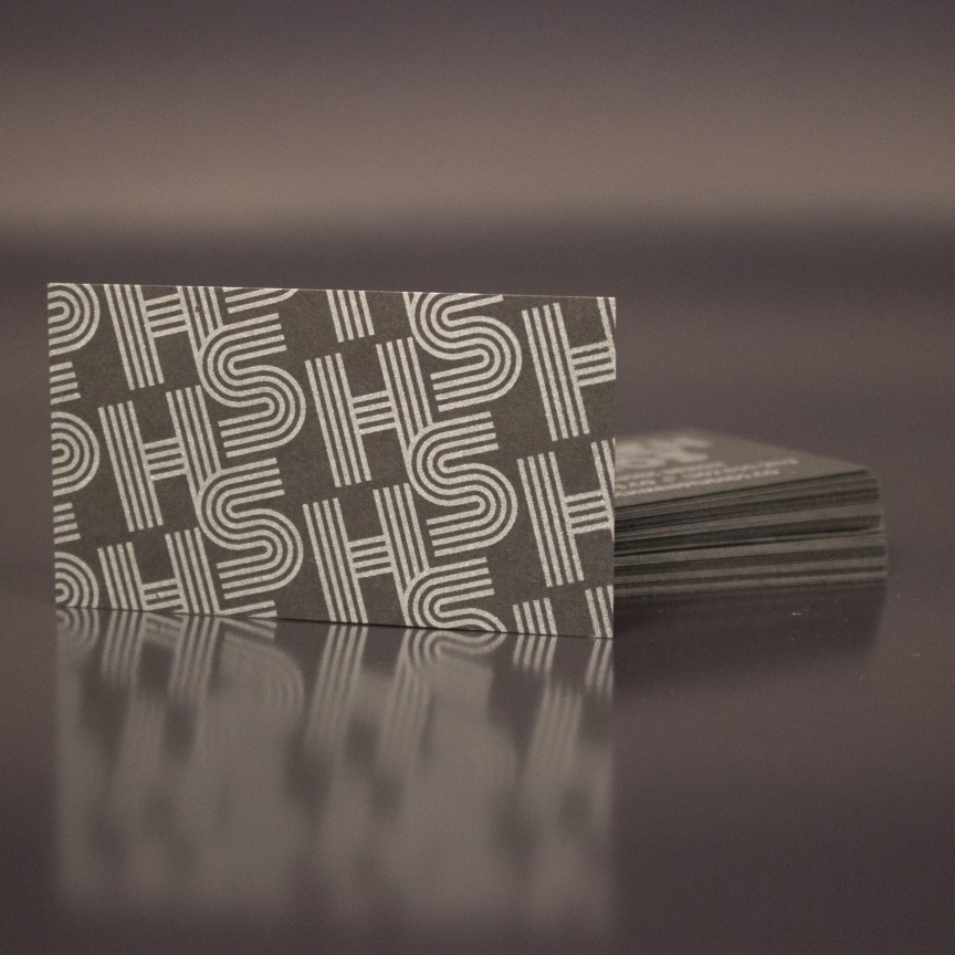 Dark gray business card with SUV font on it