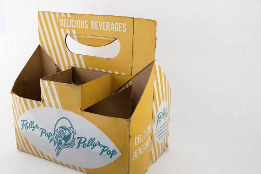 Yellow bottle carrier with green Polly's Pop logo on it